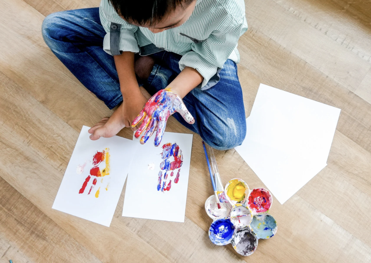 Student creating handprint art
